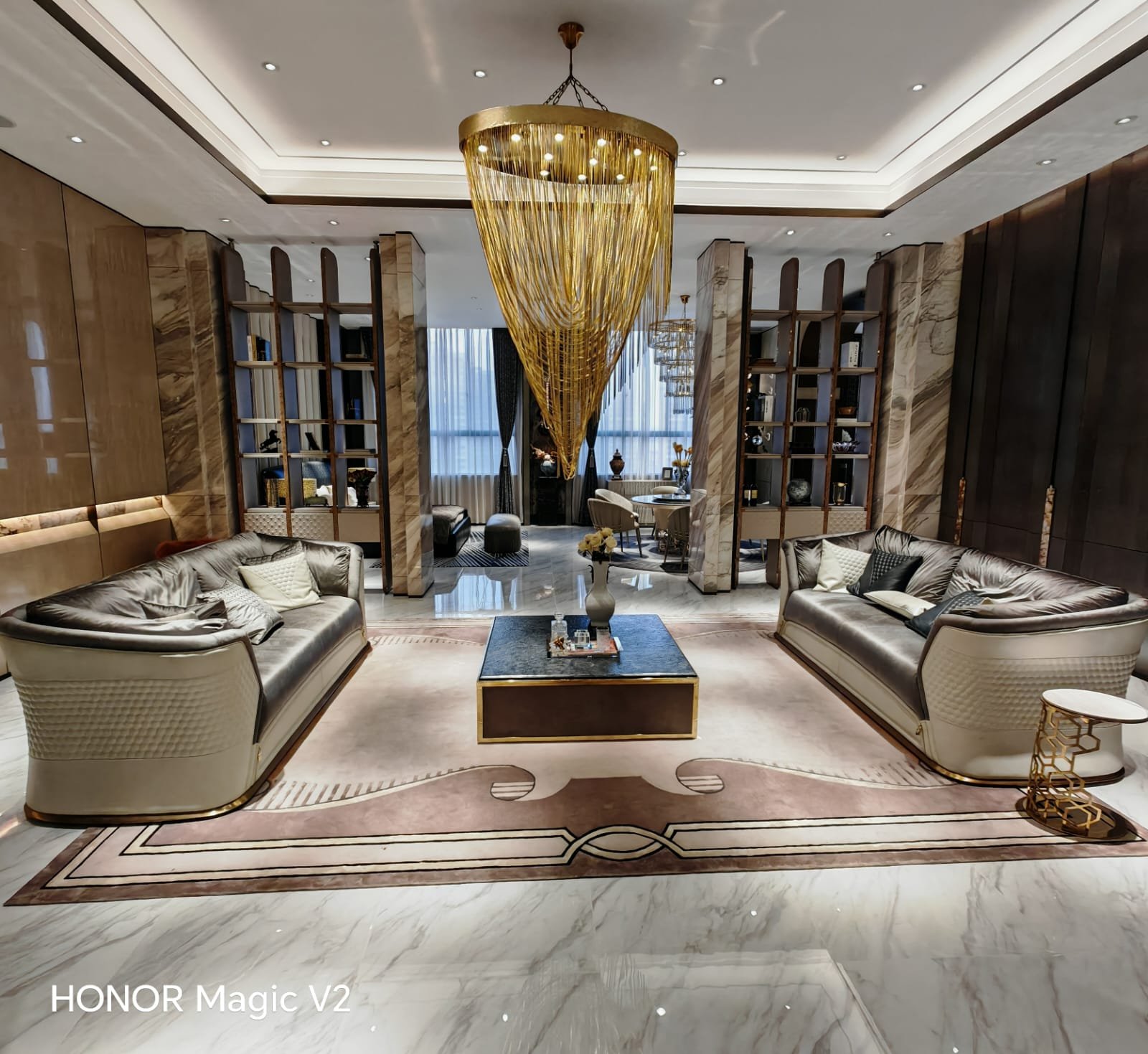 Luxury reception room with marble columns and a gold cascade chandelier